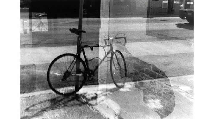 B&W photo of a reflection of a bicycle