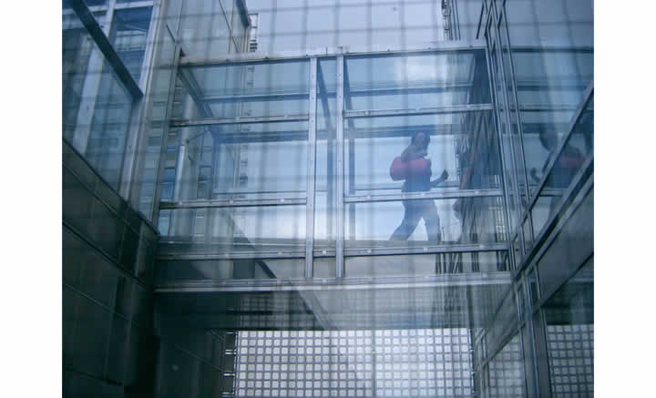 Color photo of a bridgeway between buildings